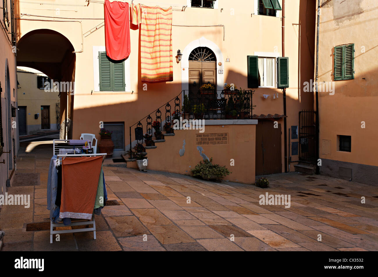 Bed linen and clothes washing in courtyard, Castellina Marittima Tuscany Italy Stock Photo