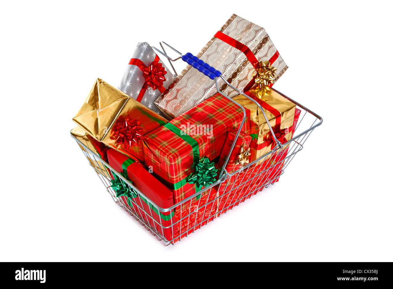 A wire shopping basket full of gift wrapped Christmas presents isolated on a white background. Stock Photo