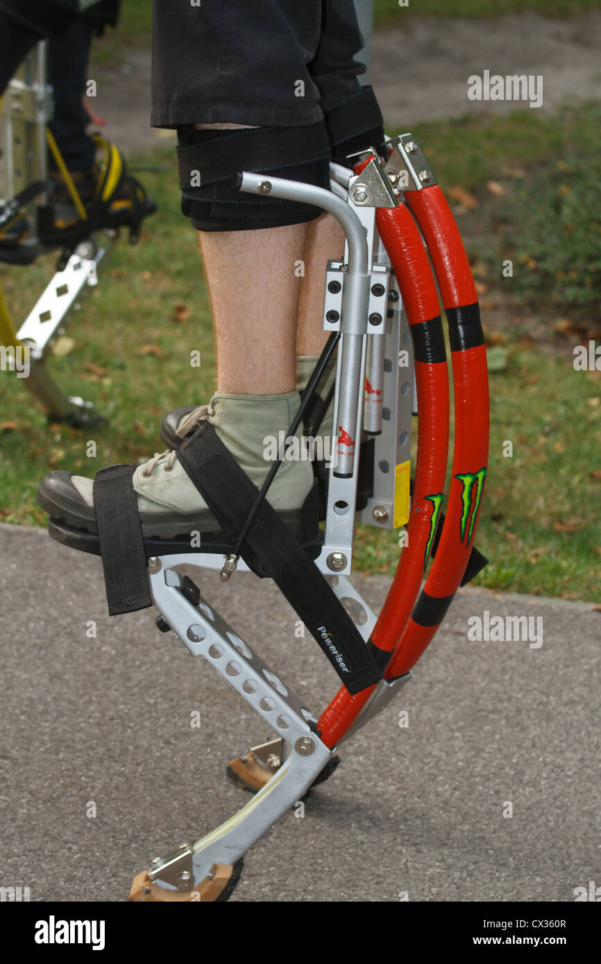 Young people wearing jumping stilts exercising in the park Stock Photo Alamy