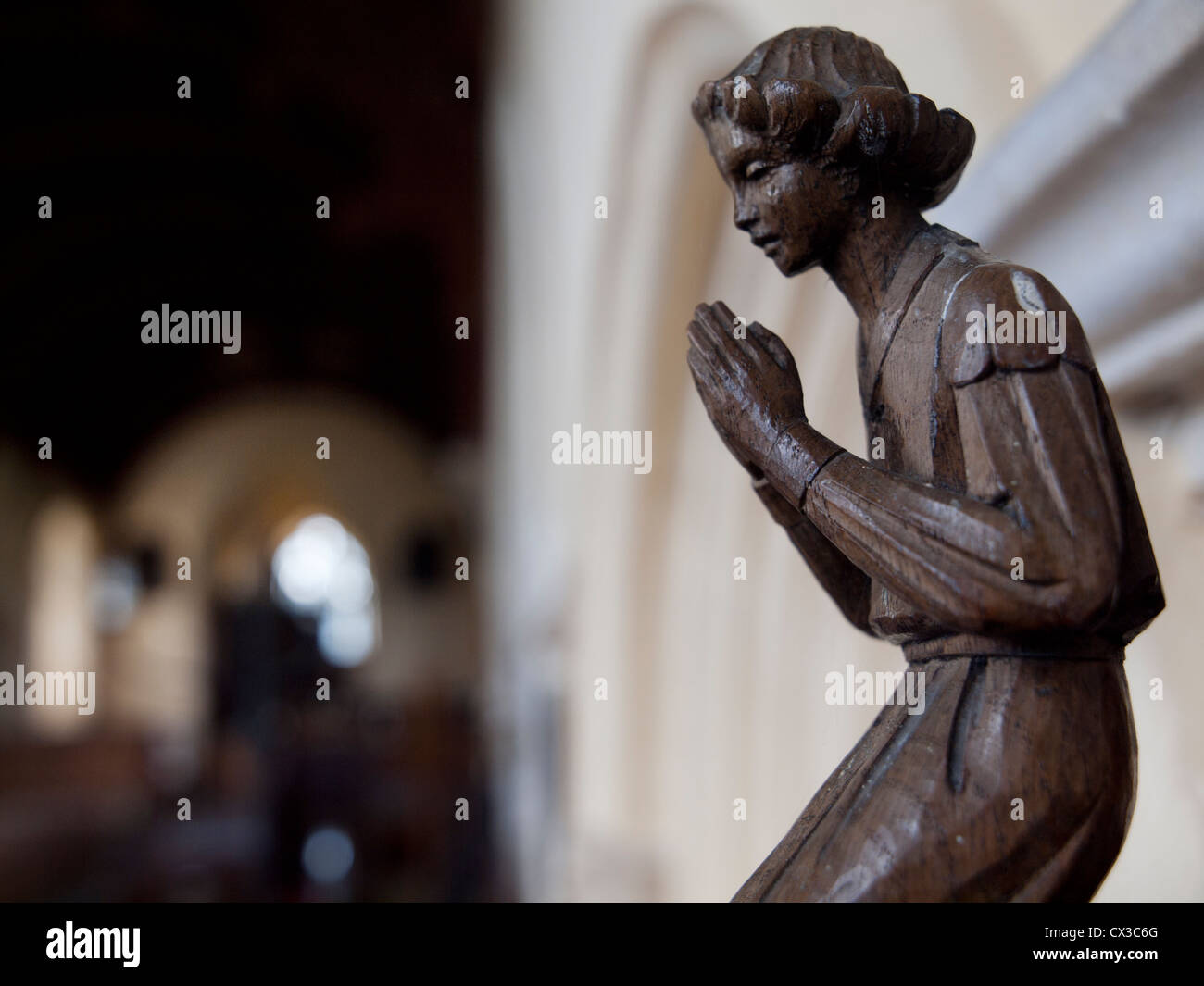 A wooden carving of a praying figure in St Mary's Church,Burgate,Suffolk. Stock Photo