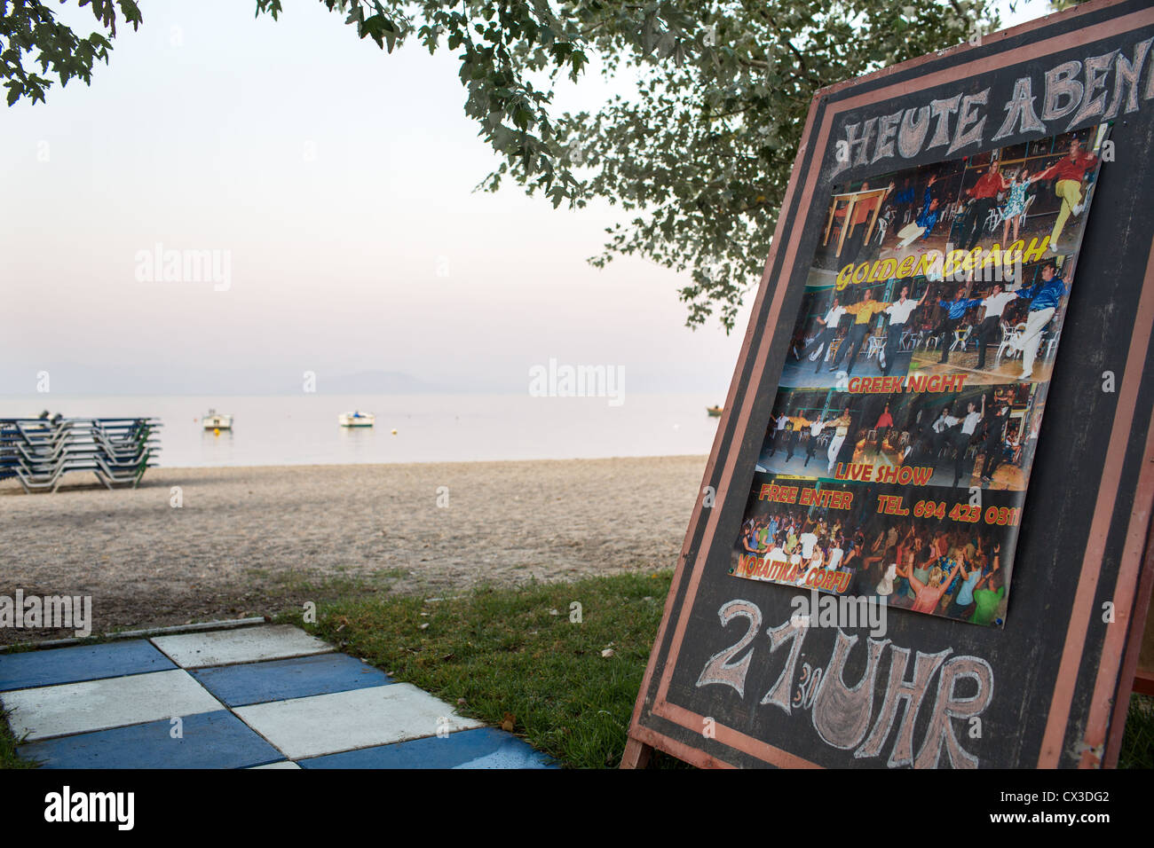 Information sign an the beach advertises a restaurant in Moraitika, Corfu, Ionian Islands, Greece. Stock Photo