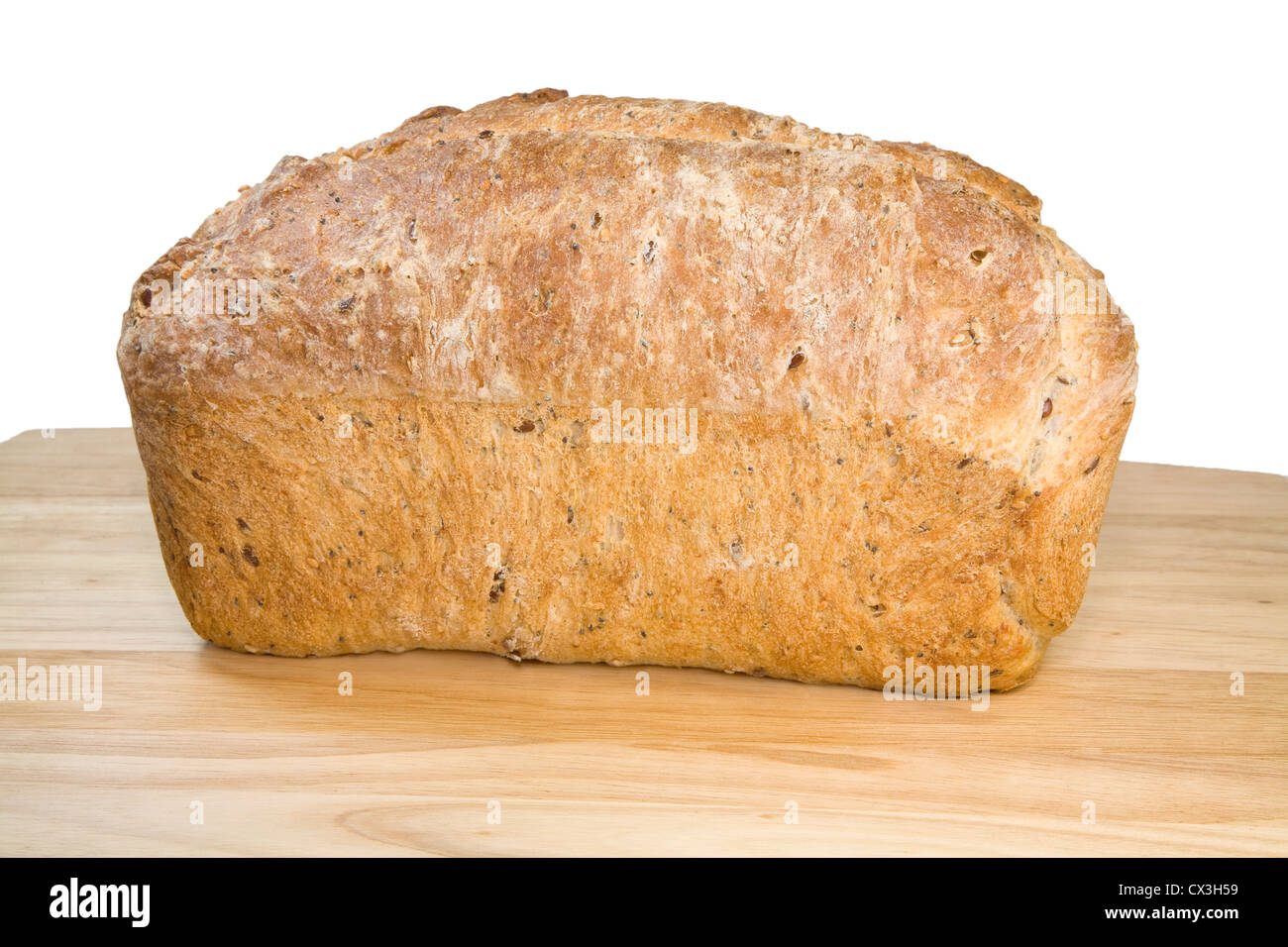 A loaf of homemade multi grain bread on a wooden cutting board Stock ...
