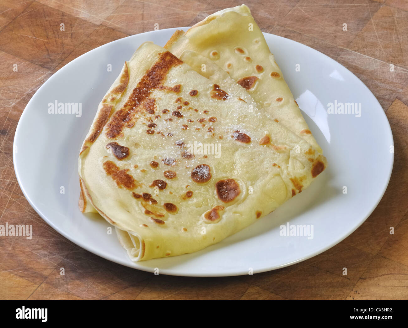 French pancake in plate on golden background Stock Photo Alamy
