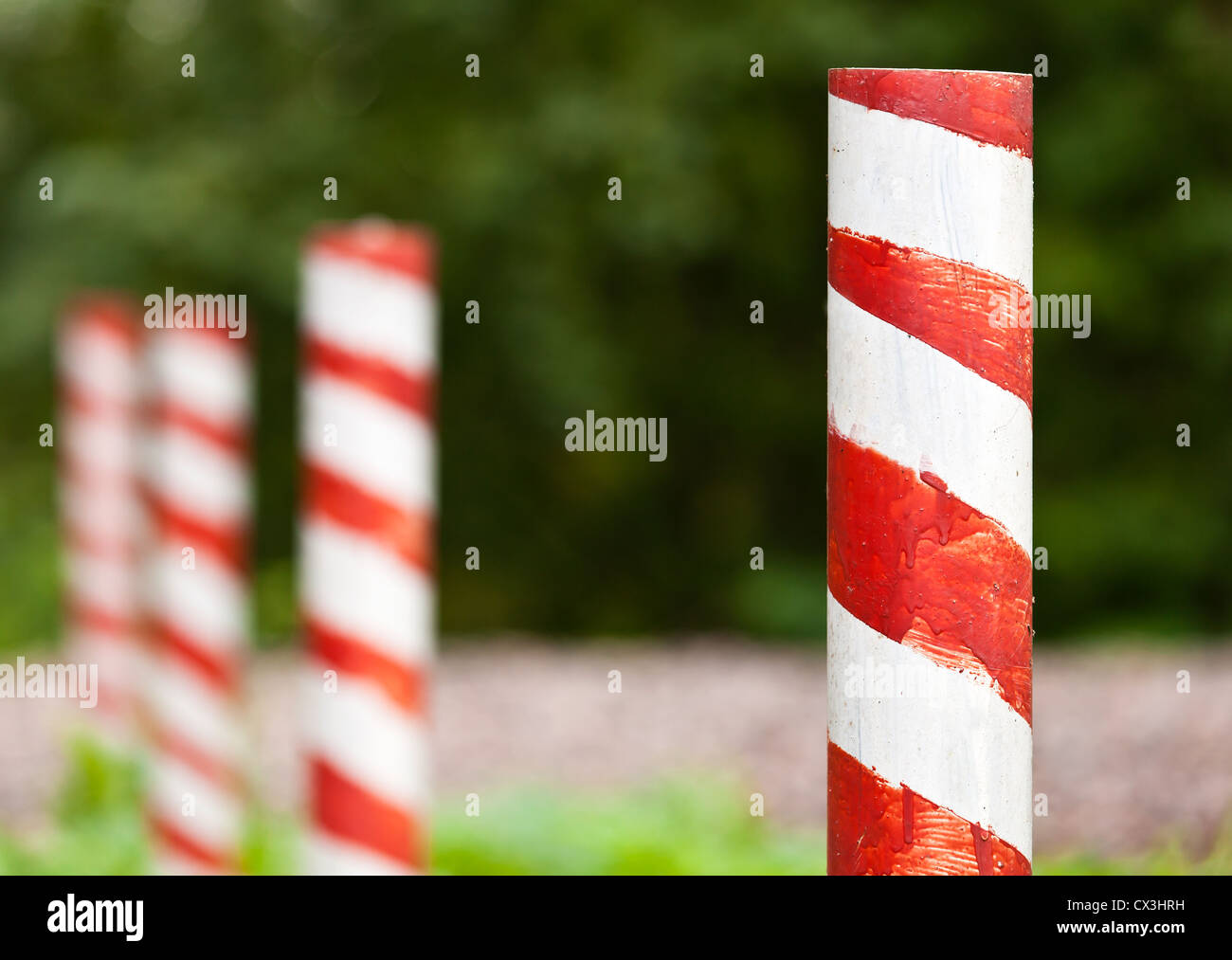 Red and white striped poles in the row Stock Photo