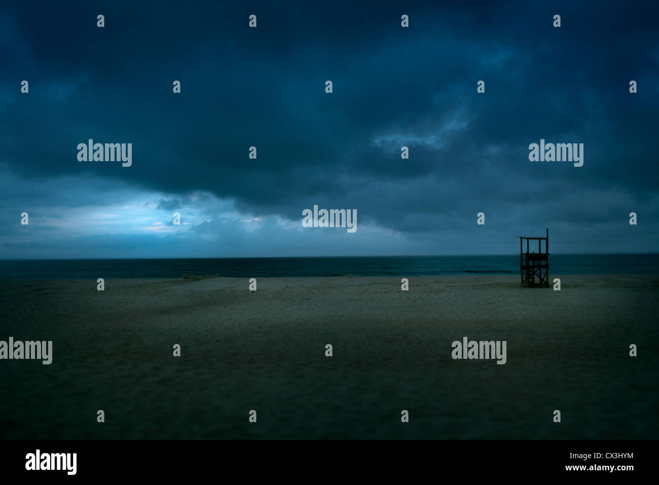 Lifeguard stand on an empty beach as storm approaches. Stock Photo