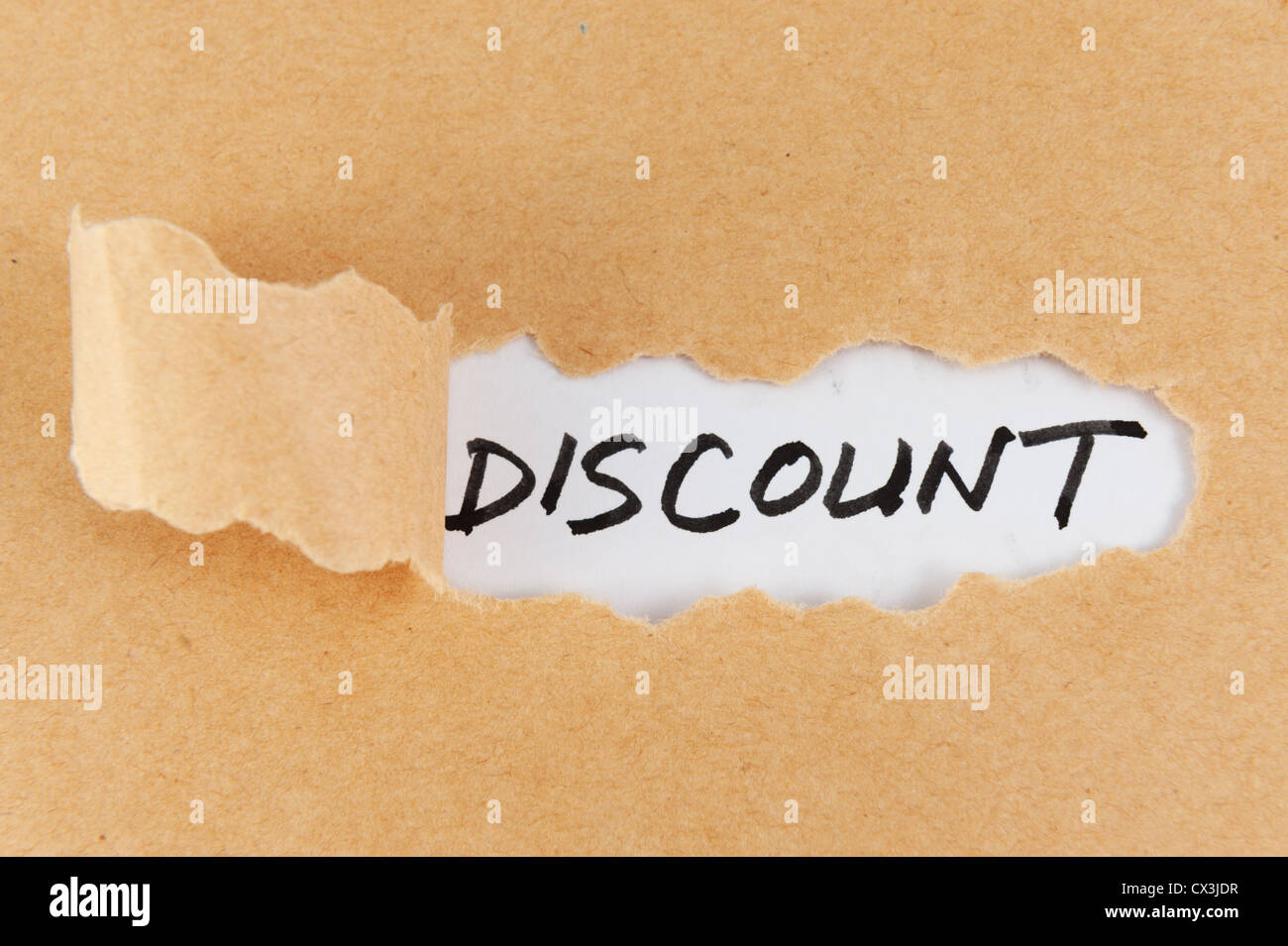Torn paper with discount word behind it Stock Photo