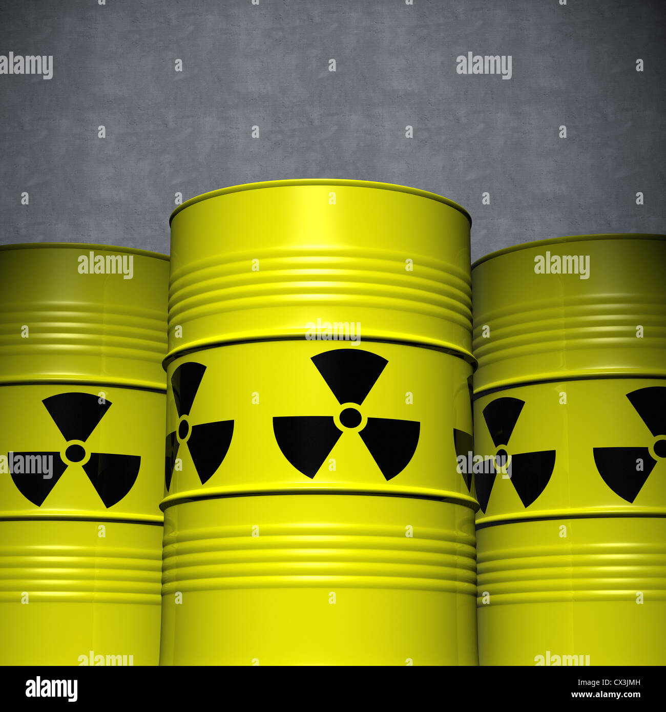 3 Fässer mit Atommüll vor einer Betonwand - Three Clean Yellow Steel Barrels with Nuclear Waste Stock Photo