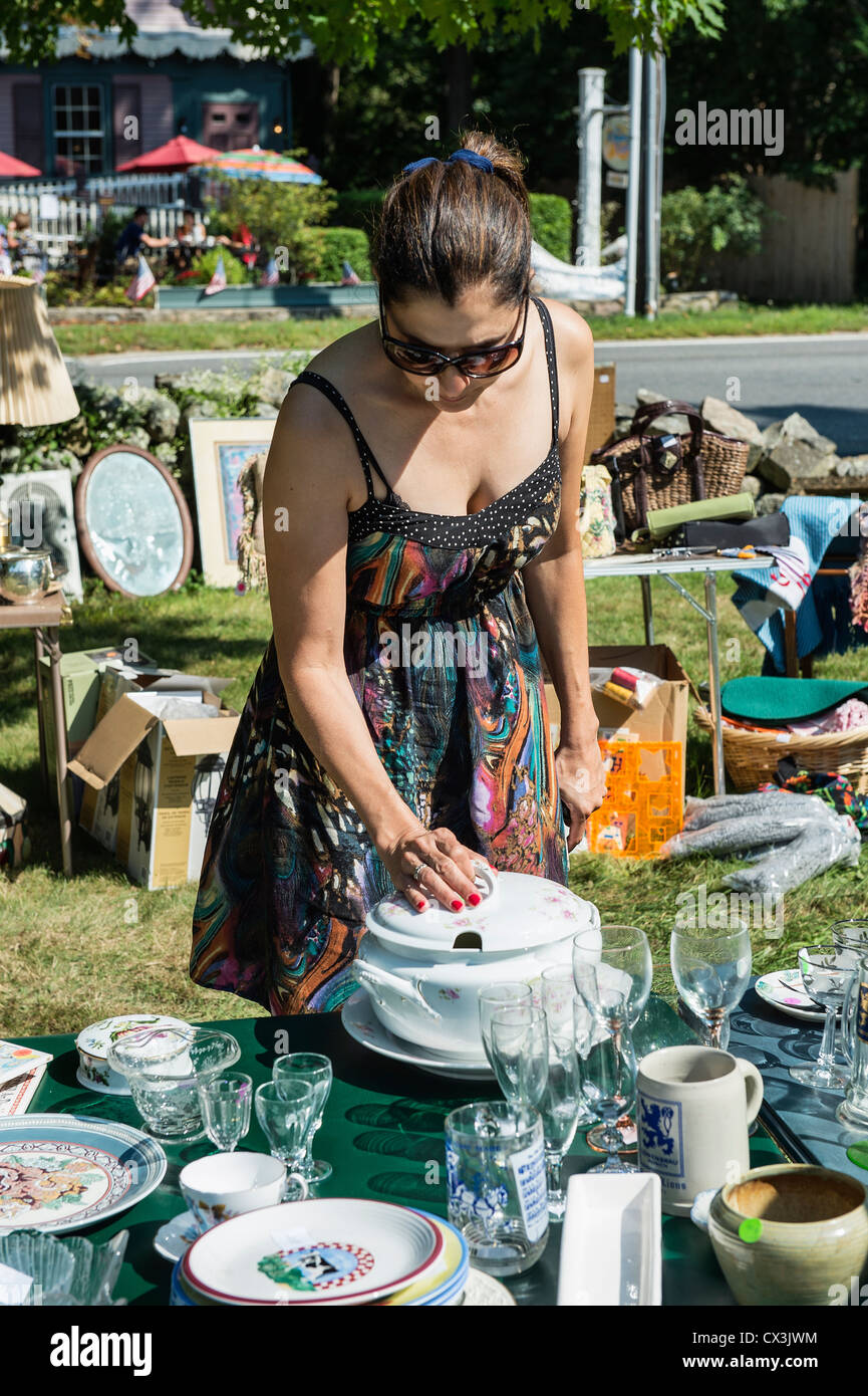 Woman shopping for bargains at a garage sale. Stock Photo
