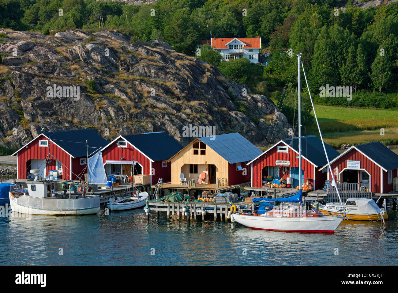 Red wooden boat huts in the harbour at Hamburgsund, Bohuslän, Sweden ...