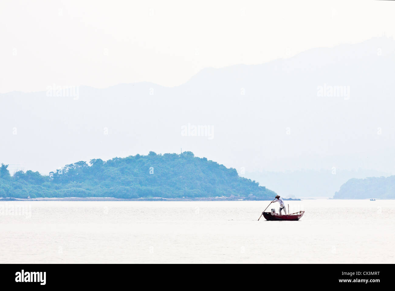 Fisherman over the mountain and the sea alone Stock Photo