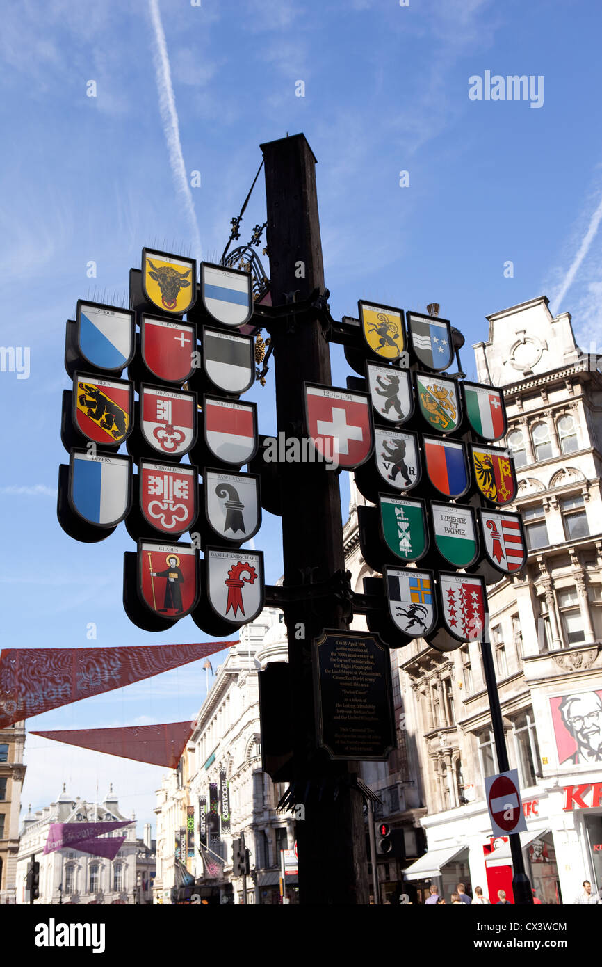 Antique Swiss Inn sign in Leicester Square given to Great Britain from Switzerland to celebrate Queen Elizabeth's silver jubilee Stock Photo