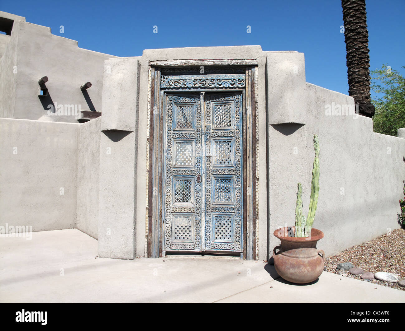 Old vintage beautifully crafted blue aged Mexican style wooden doorway Stock Photo