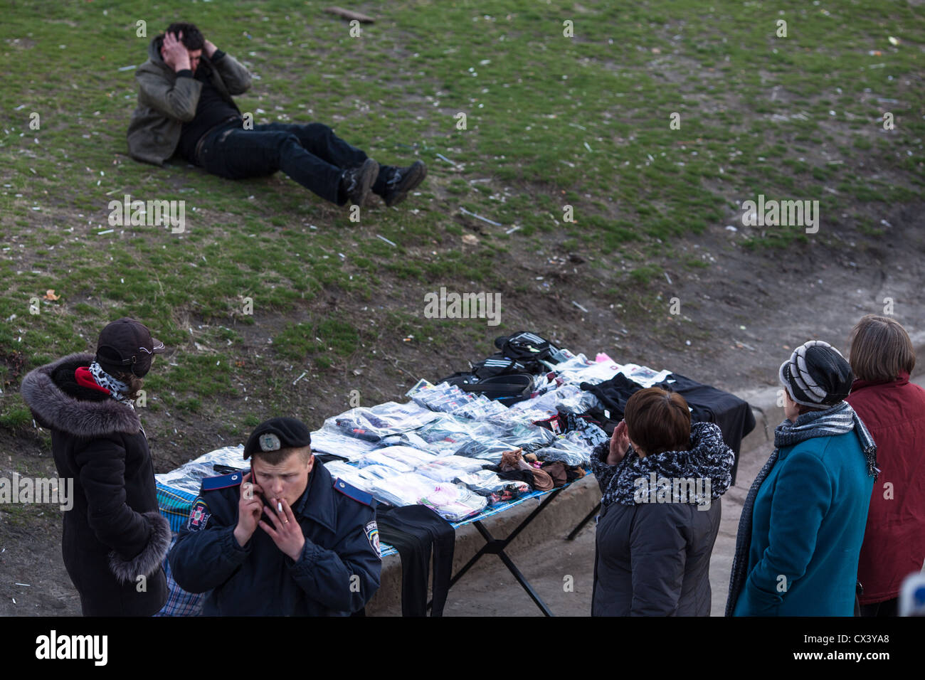 Drunk man sits on the lawn in the outskirts Osokorki in Kiev, Ukraine, Eastern Europe. Stock Photo