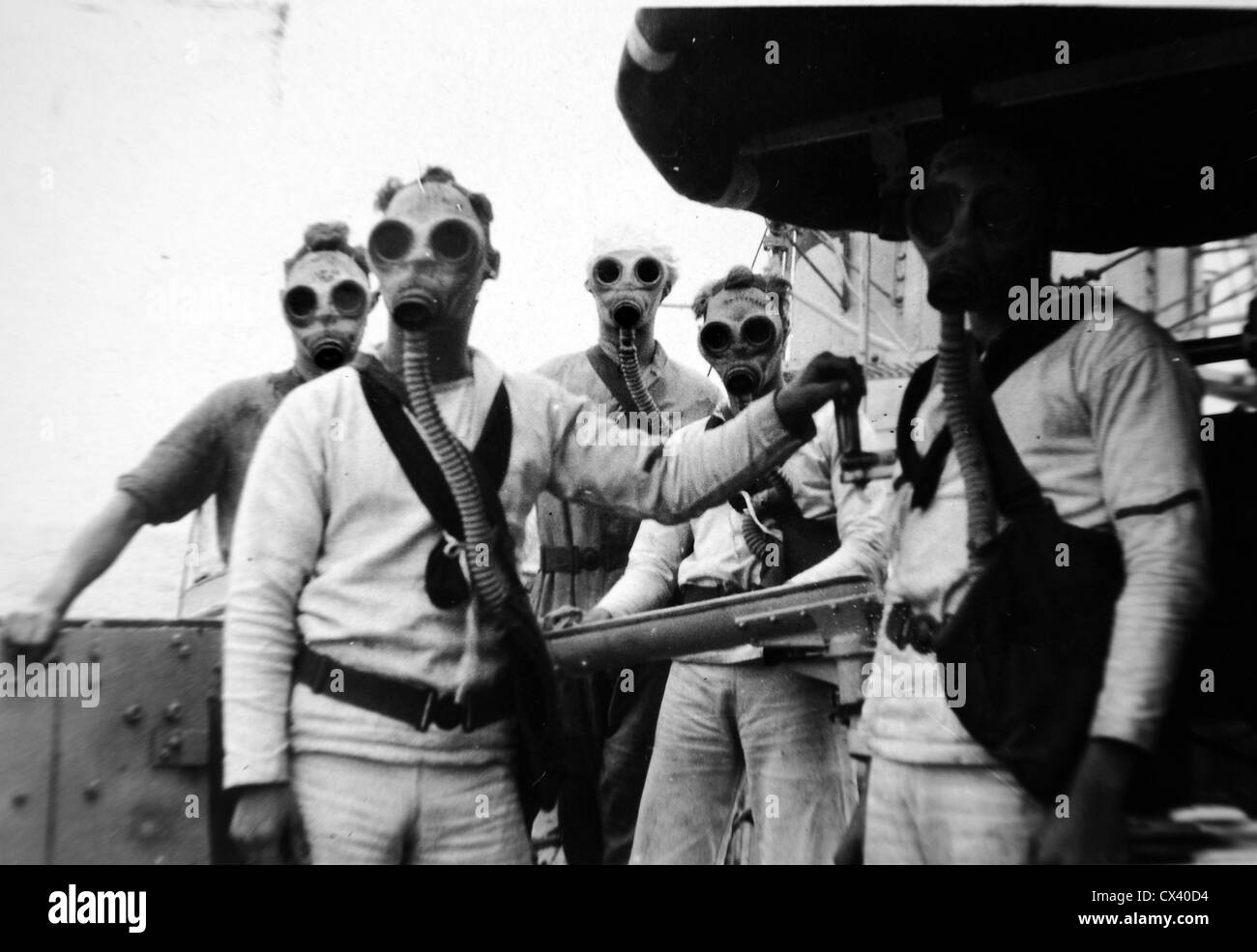 Royal Navy World War Two. Gas masks worn by a gun crew in action Stock Photo
