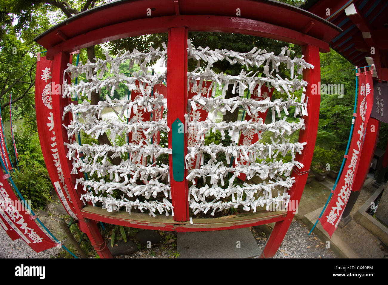 Paper prayers tied to strings at a Buddhist temple in Tokyo, Japan. Stock Photo