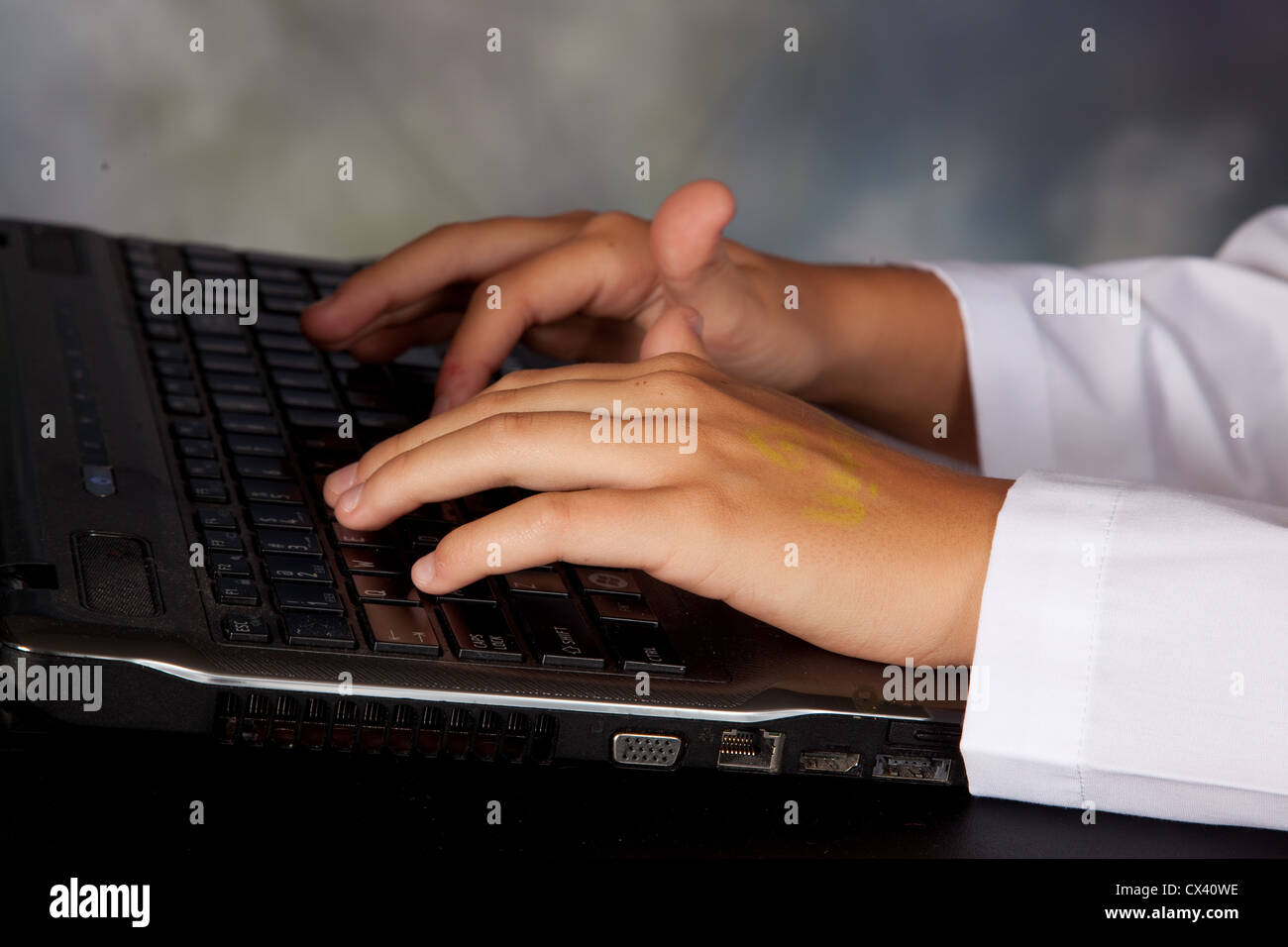 Hands , typing on a laptop computer Stock Photo - Alamy