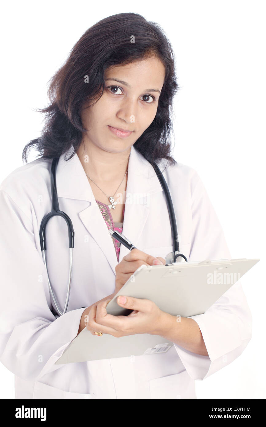 Young Indian female doctor with clipboard against white Stock Photo - Alamy