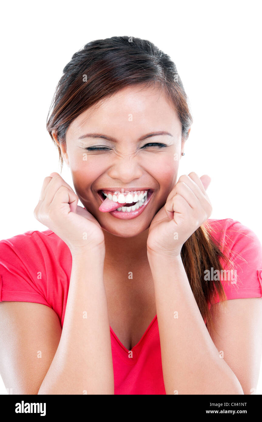 Happy young woman laughing with tongue sticking out, portrait