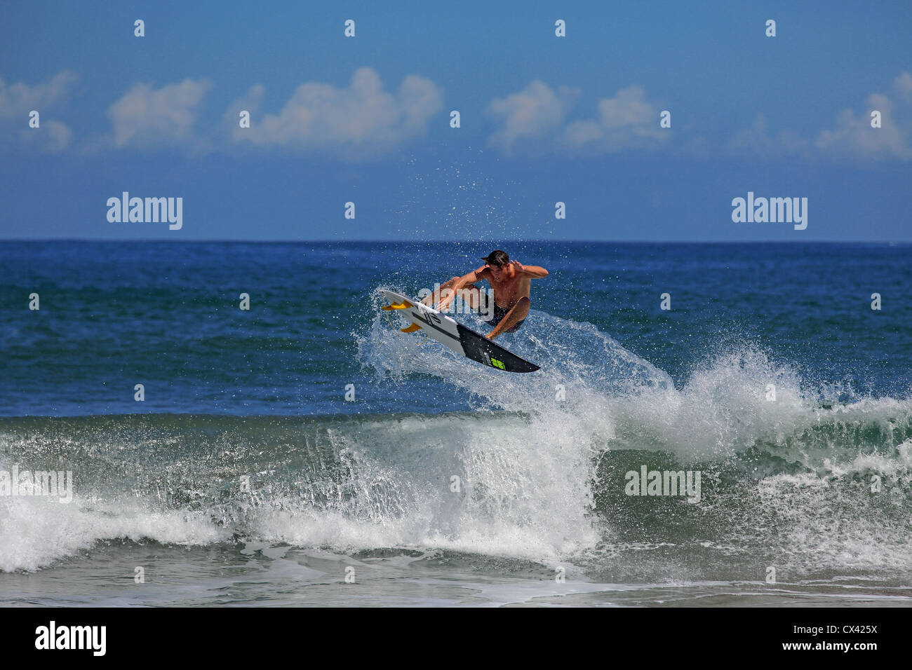 Australian surfer surfing a beach break wave in Sumatra, Indonesia. Stock Photo