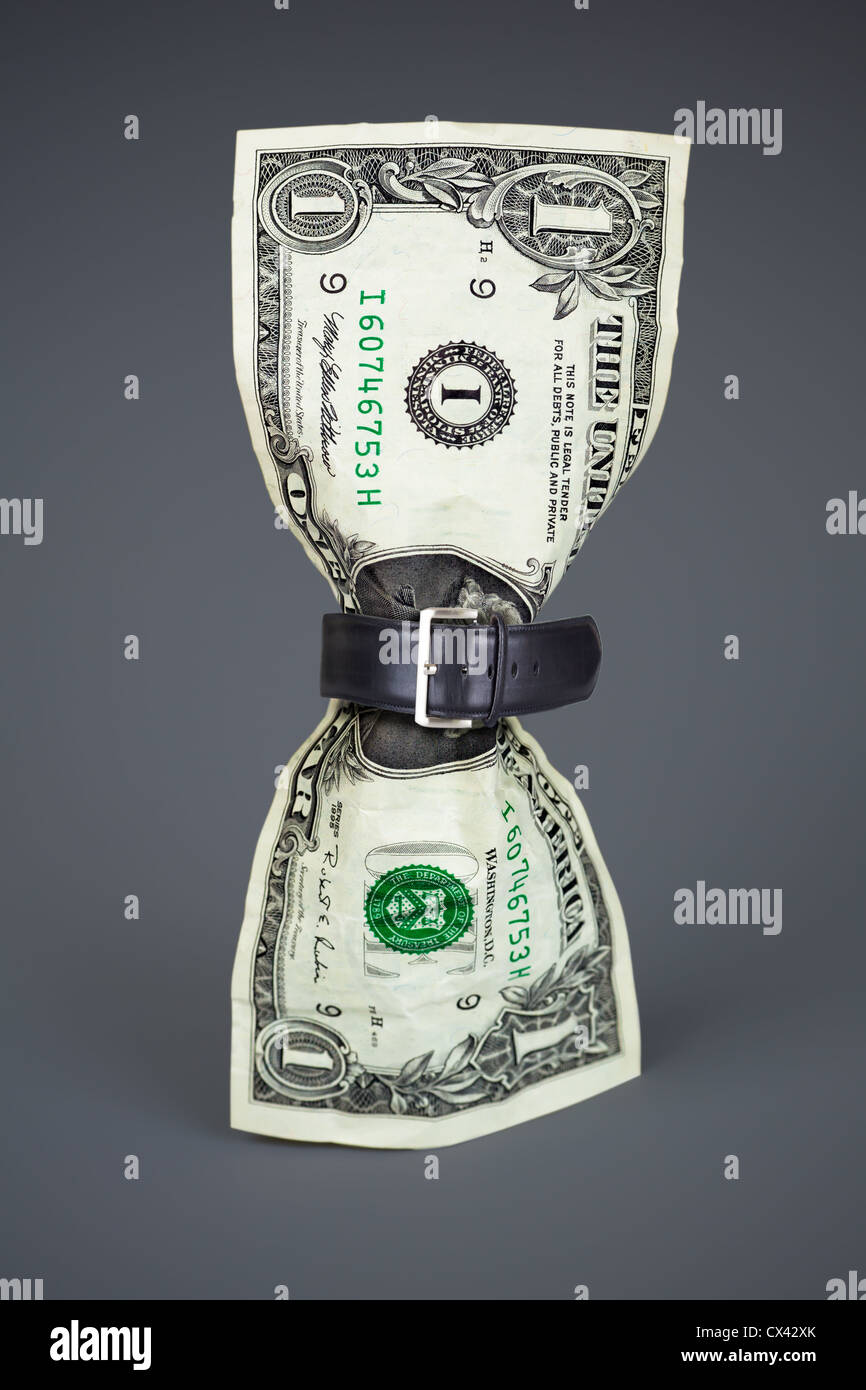 tighten belt on dollar concept Stock Photo Alamy