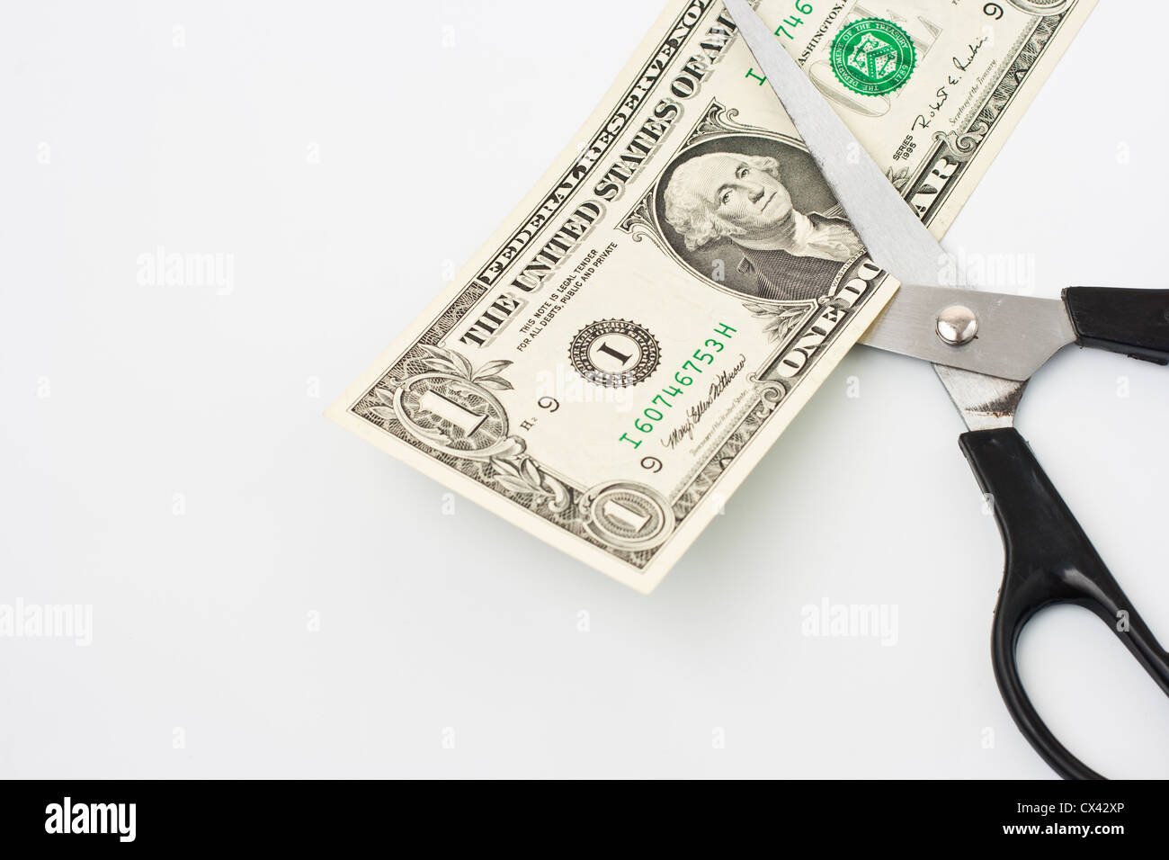 Scissors cuts one american dollar note Stock Photo