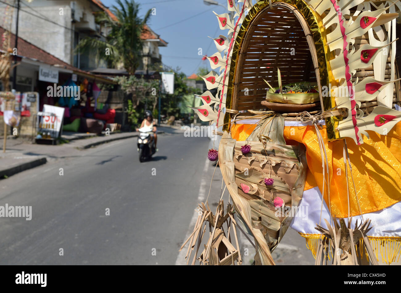 A decoration for the festival of Galungan in Seminyak; Bali, Indonesia with the ever-present scooter in the background. Stock Photo