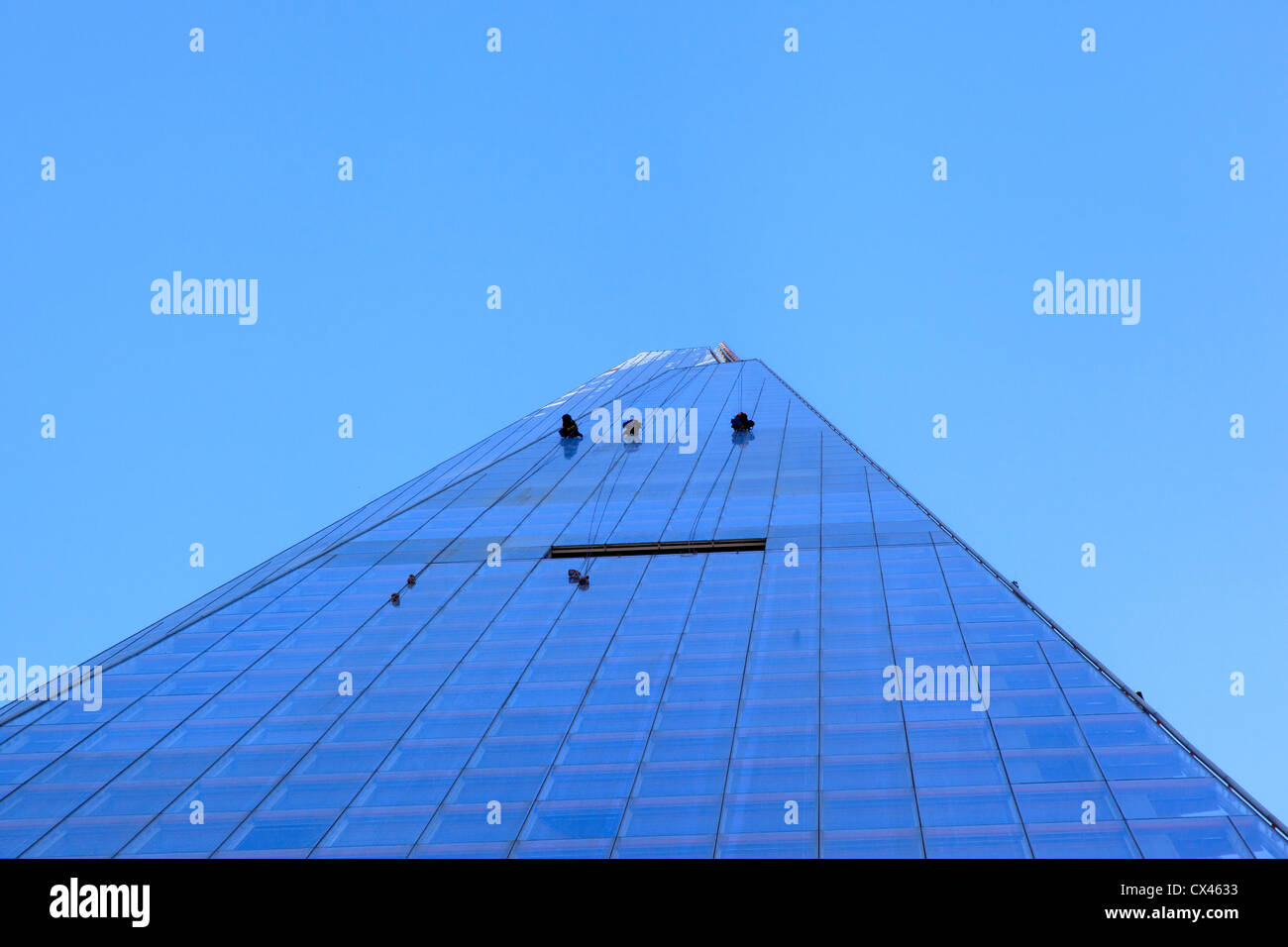 Window cleaners or maintenance workers abseiling down the Shard at London bridge Stock Photo
