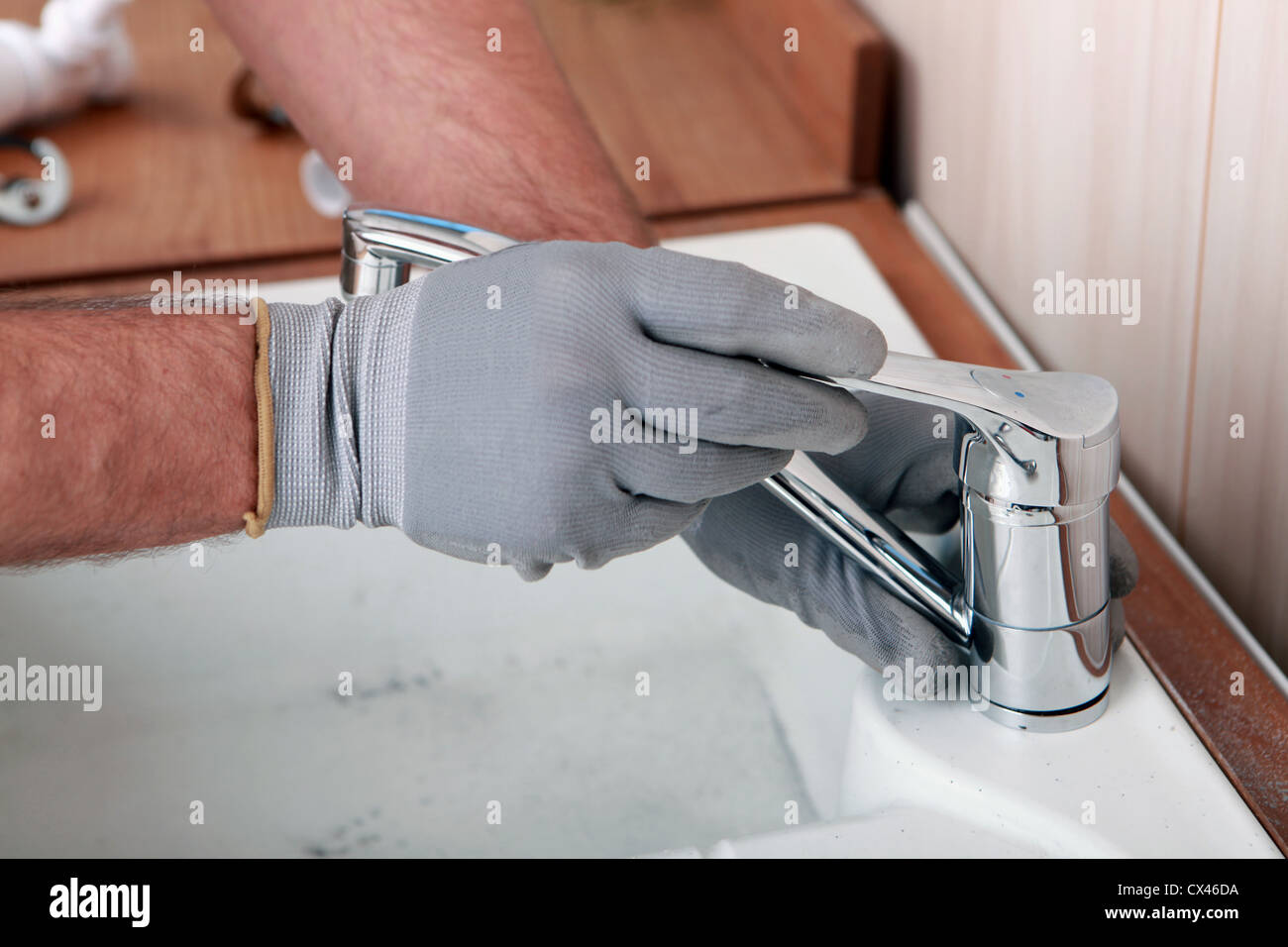 Plumber fixing a sink Stock Photo Alamy