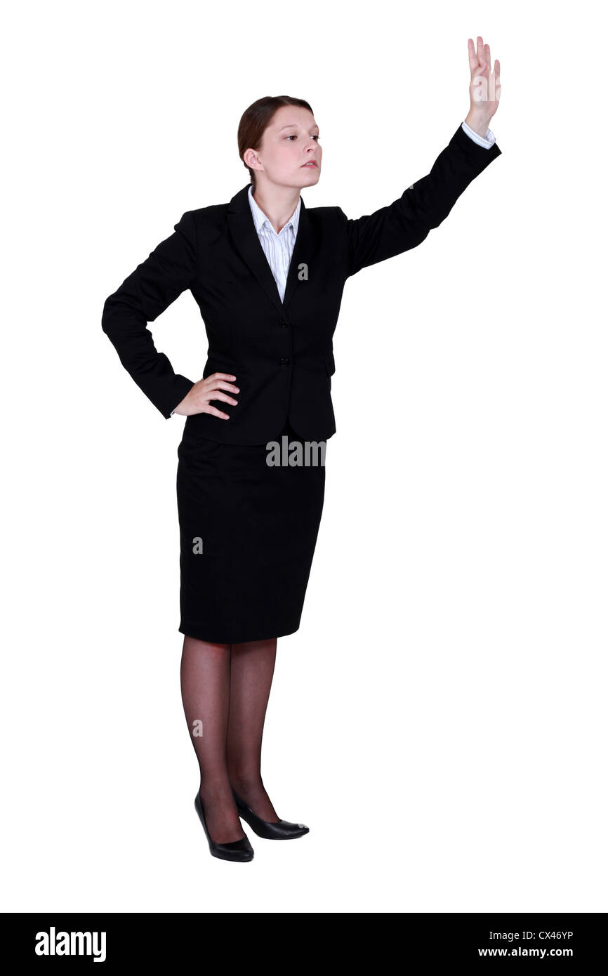Businesswoman waving someone down Stock Photo