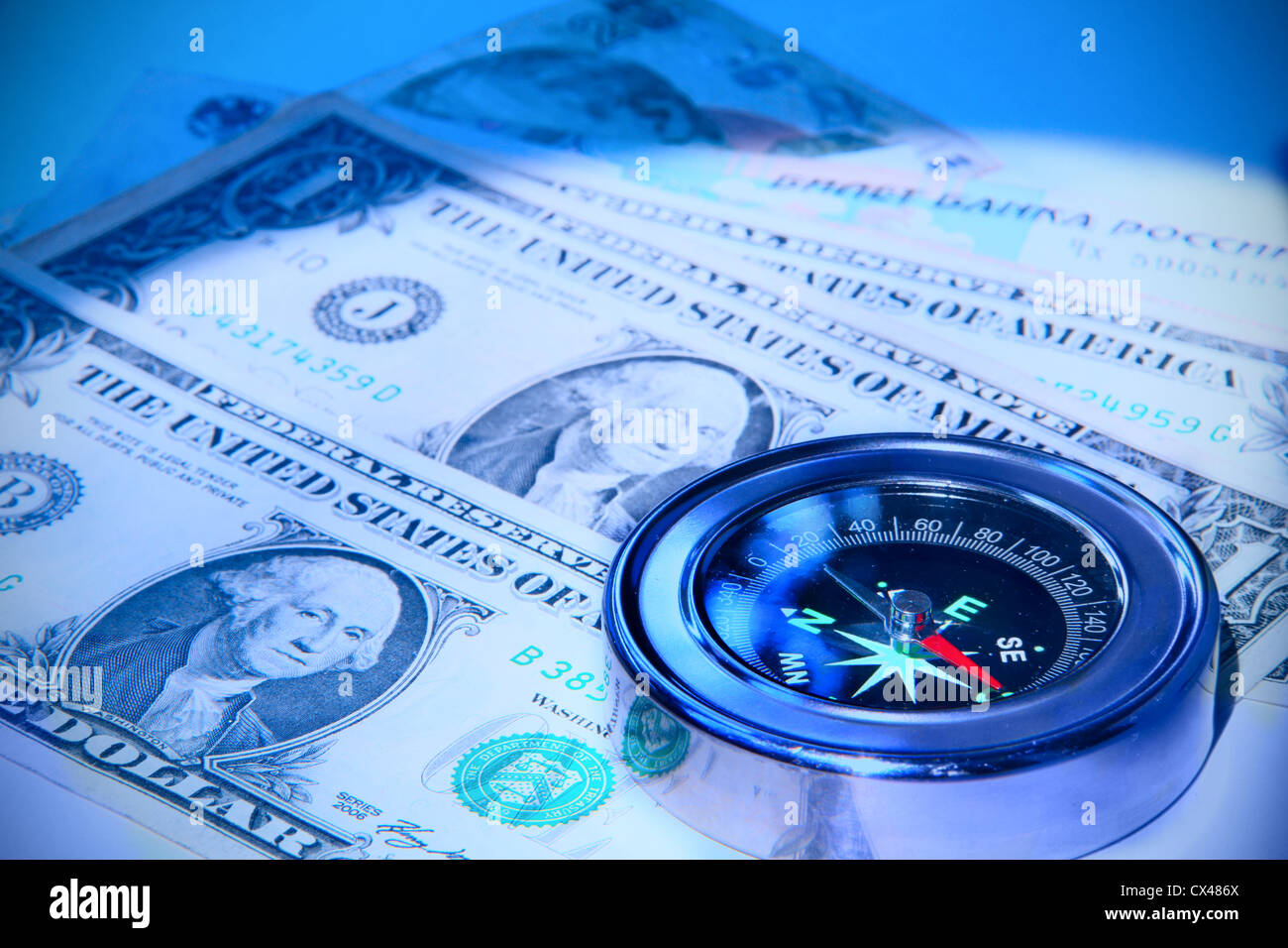 Compass over banknotes Stock Photo