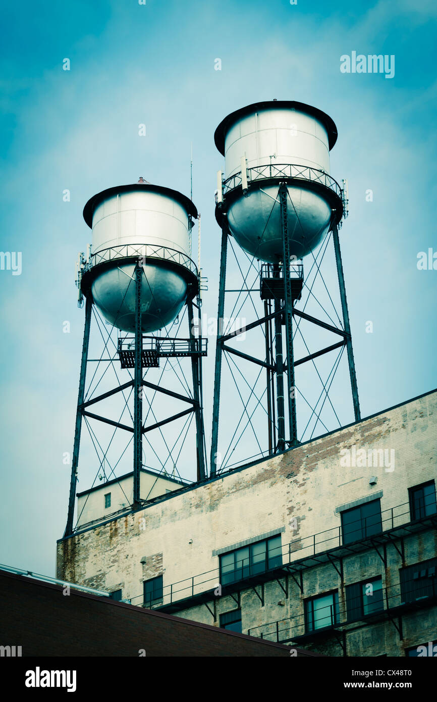 Water towers on top of old industrial buildings. Stock Photo
