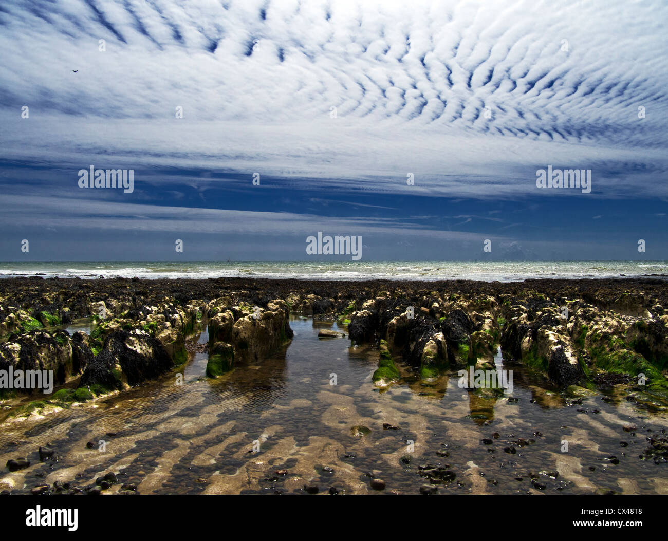 Herringbone sky pattern and chalk formations on the coast of Sussex, England Stock Photo