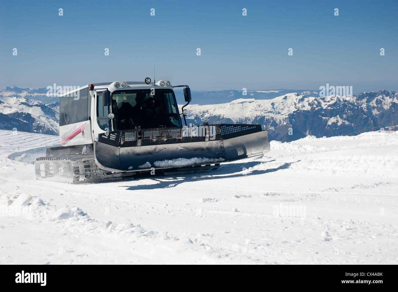 Snow groomer in the French Alps Stock Photo