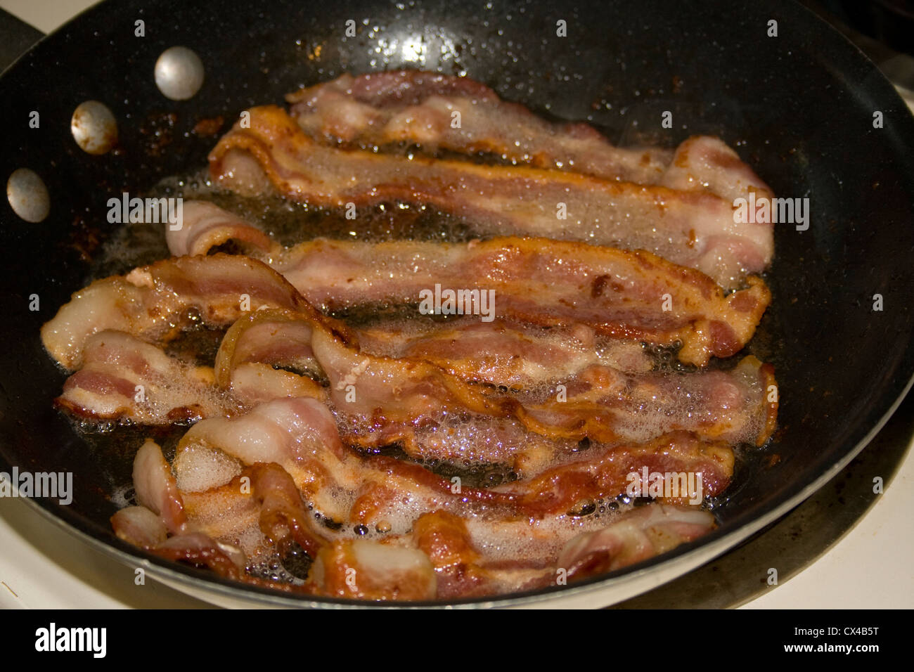 A nice pan of bacon frying Stock Photo Alamy