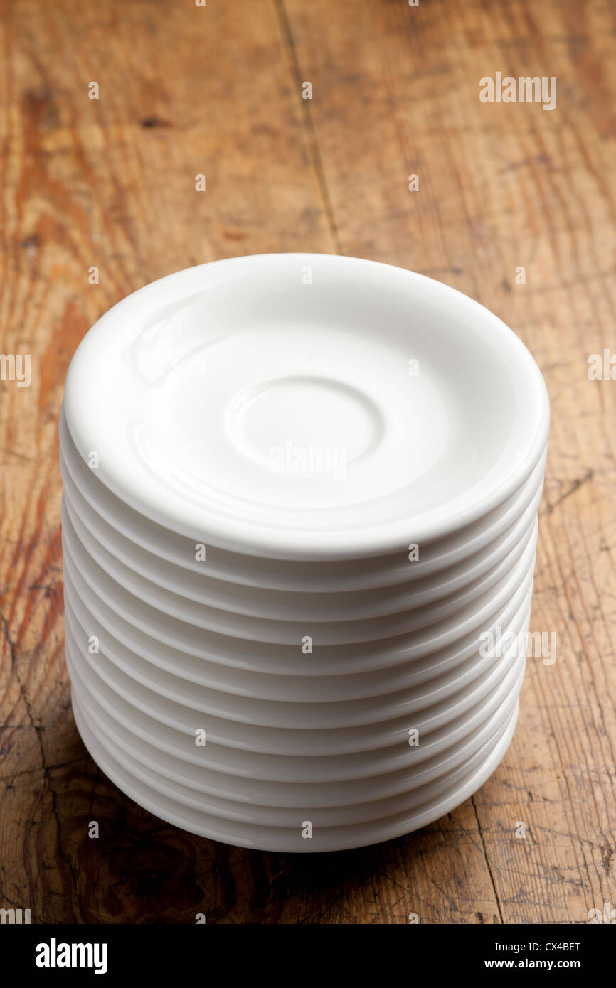 Stack of white porcelain coffee saucers Stock Photo Alamy