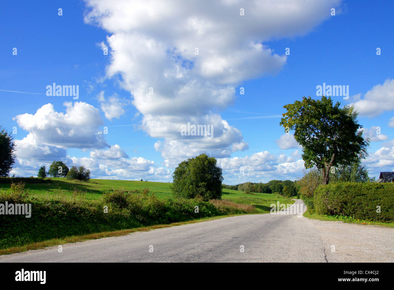Landscape with road and the cloudy sky Stock Photo - Alamy