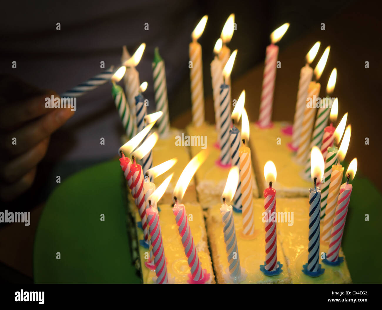 A birthday cake with lighted candles .Focus is on the candles Stock