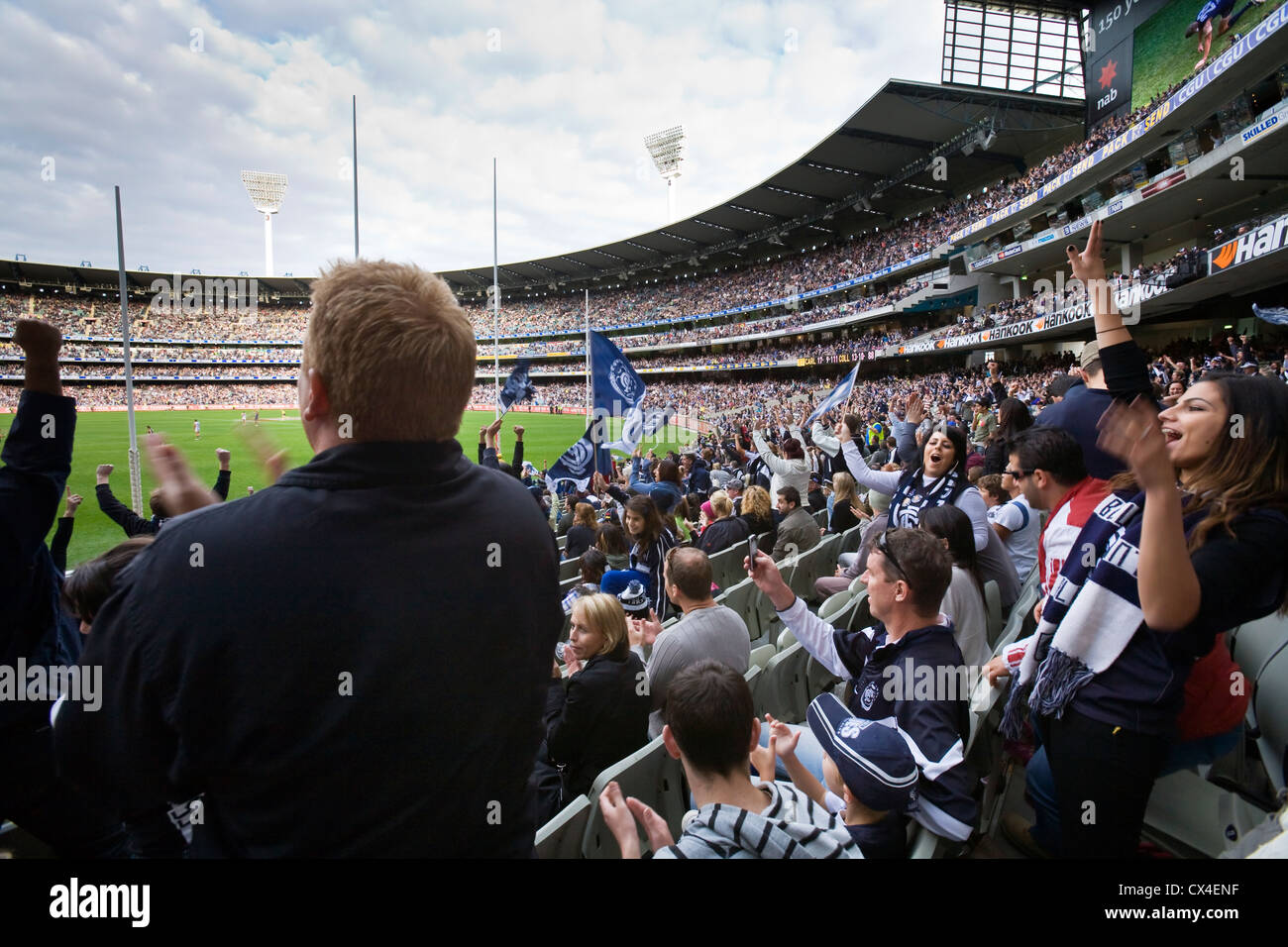 Supporters cheer on their teams during an Australian Rules football game at the MCG.  Melbourne, Victoria, AUSTRALIA Stock Photo