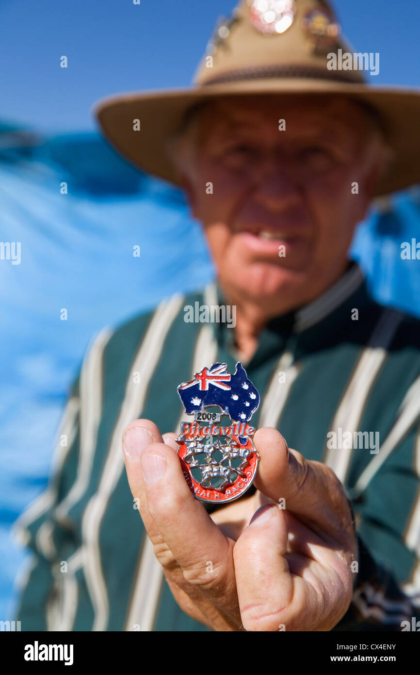 Man holding a souvenir pin for the 2008 Birdsville Races.  Birdsville, Queensland, AUSTRALIA. Stock Photo