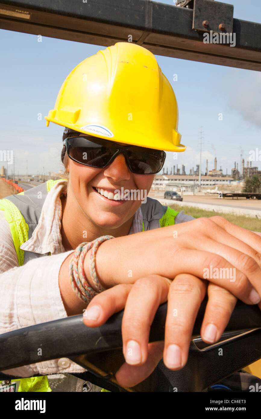 Ali Walker drives a large road rolling machine at the Syncrude Mildred Lake tar sands plant. Stock Photo