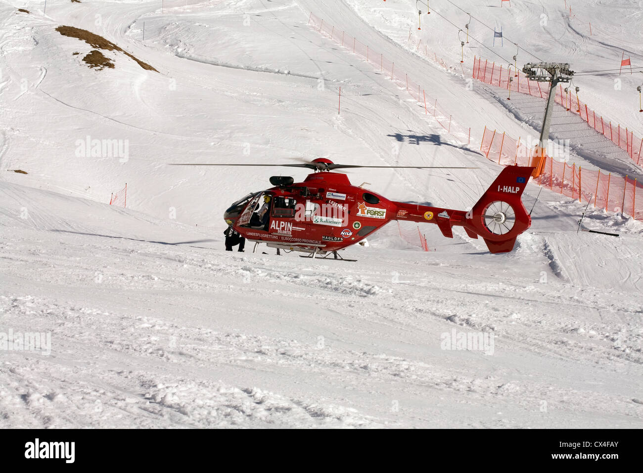 Air Ambulance attending a serious skiing accident on a piste in Selva Val  Gardena Dolomites Italy. Helicopter type EC 135 Stock Photo - Alamy