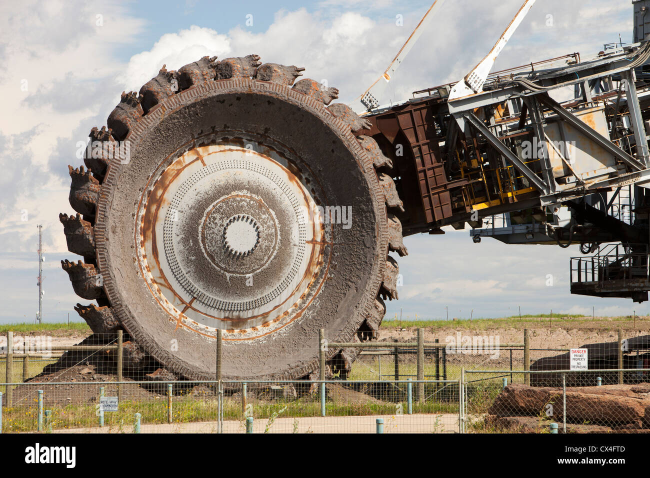 A massive bucket wheel by the Syncrude upgrader plant. The tar sands are the largest industrial project on the planet, Stock Photo