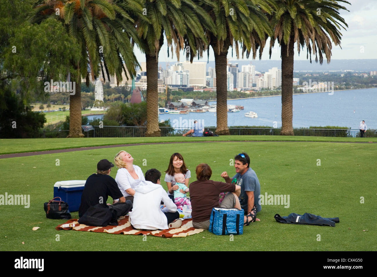 A family picnic at Kings Park with the Perth skyline in background. Perth, Western Australia, AUSTRALIA. Stock Photo
