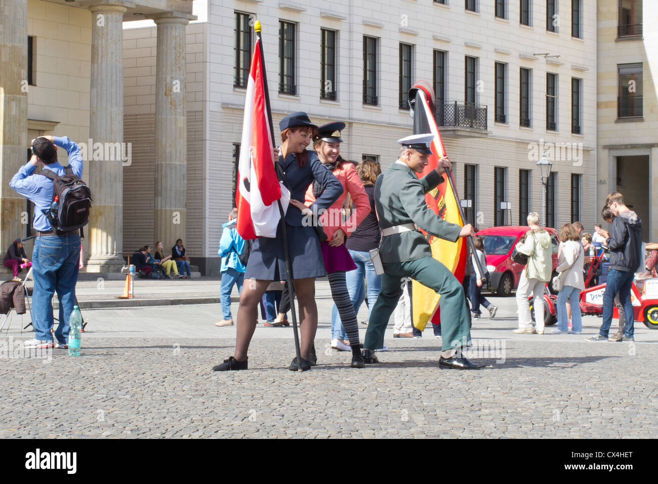 Berlin at the Brandenburg Gate  border guards and tourists posing to have their picture taken - Pariser Platz Stock Photo
