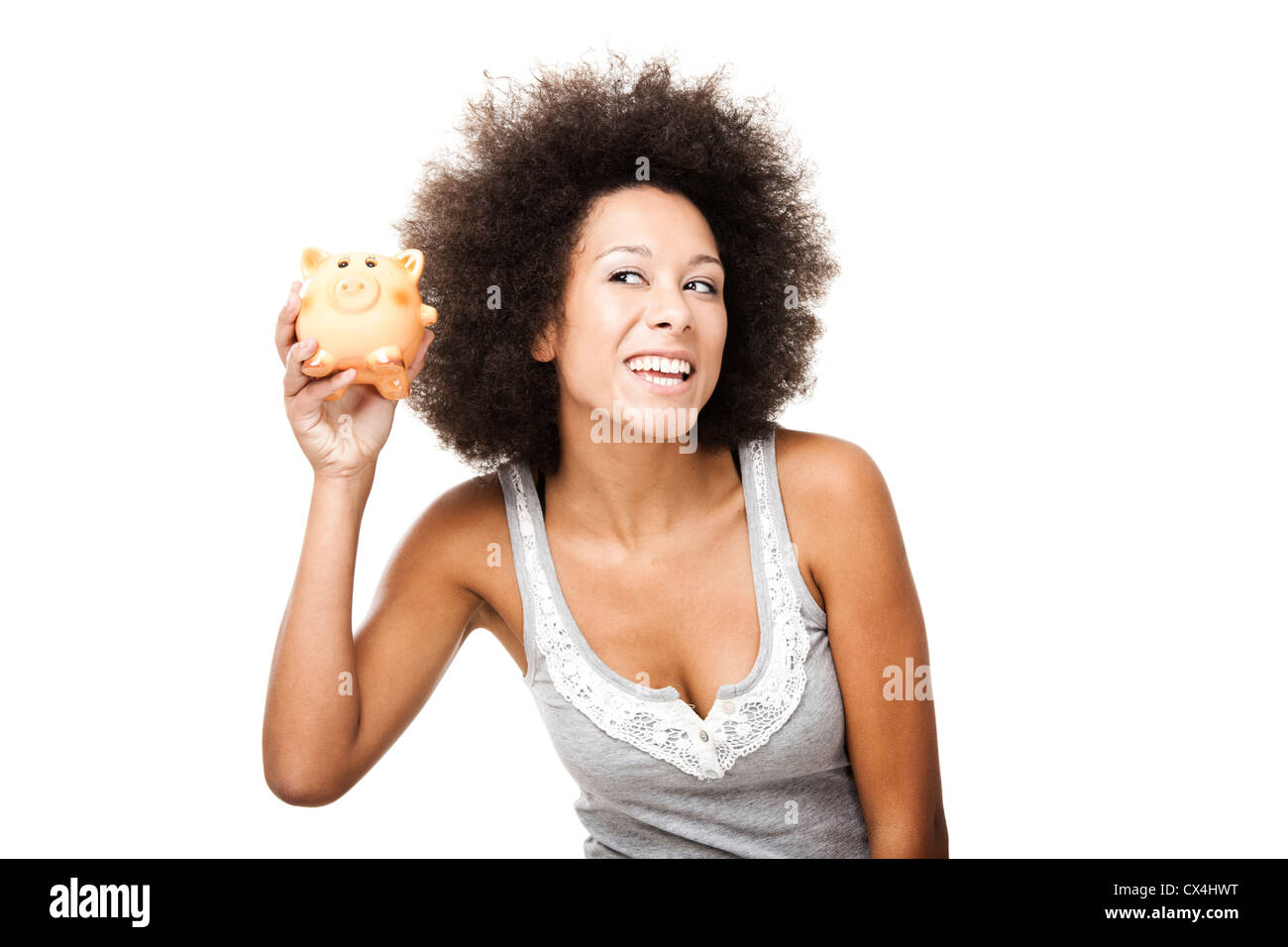 Woman holding and shaking a piggy bank Stock Photo - Alamy