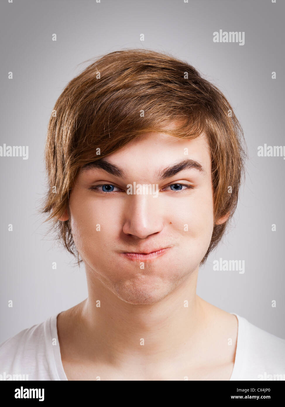 Portrait of a handsome young man, over a gray background Stock Photo ...