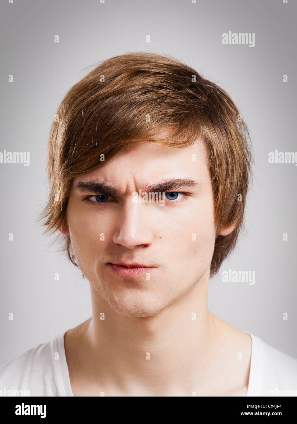 Portrait of a handsome young man, over a gray background Stock Photo ...