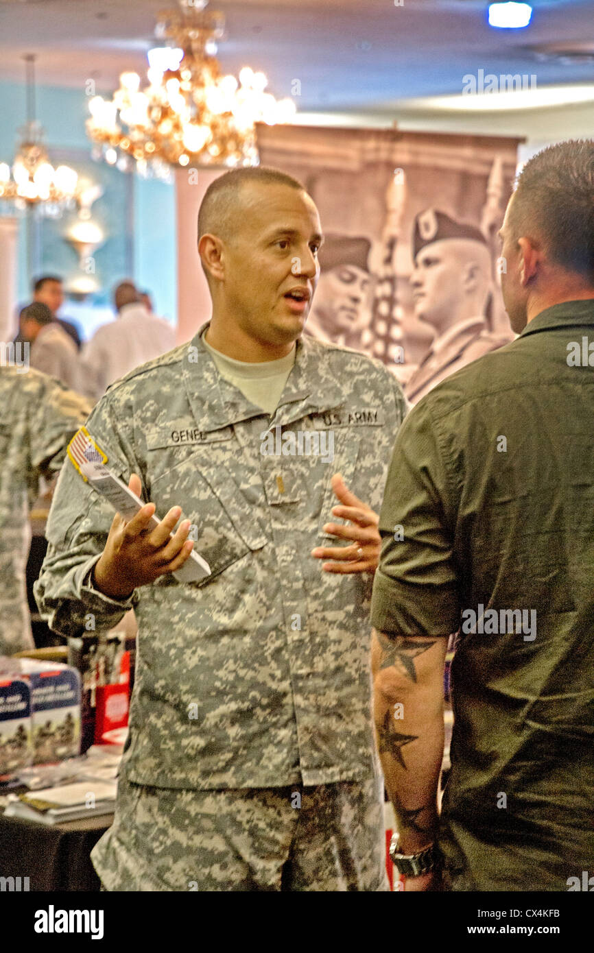 A U.S. Army National Guard recruiter talks with a young man at a job fair for military veterans in Santa Ana, CA. Stock Photo