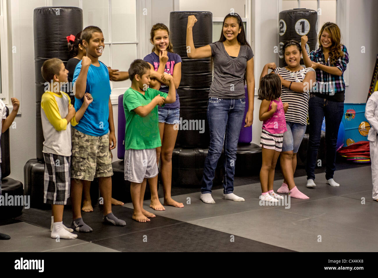 Children in a San Juan Capistrano, CA, anti bullying class display their upper arm strength. Note Hispanics. Stock Photo