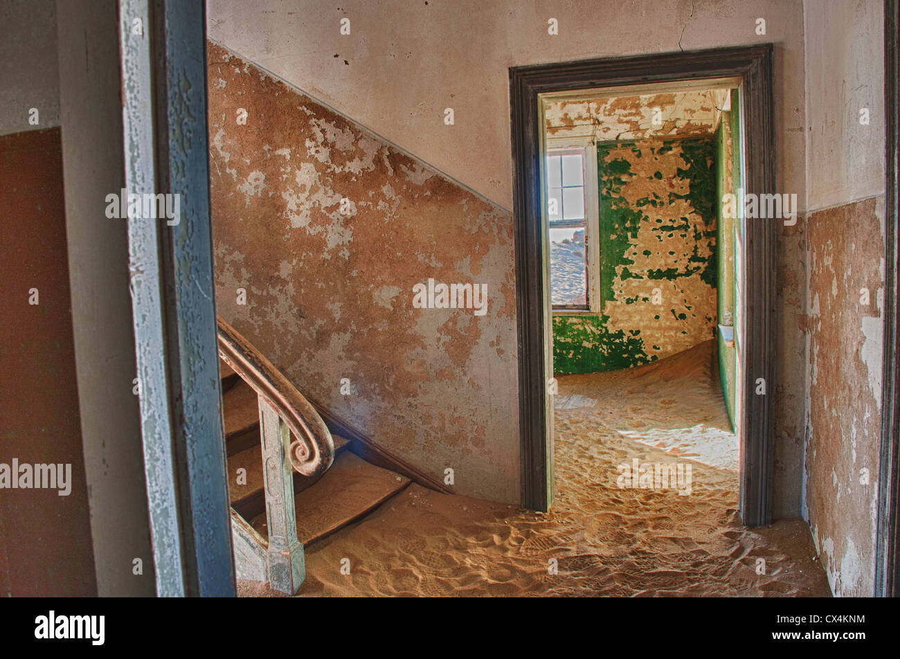Interior room in Kolmanskop, a ghost mining town in Namibia, Africa. The desert has reclaimed the town after it was abandoned. Stock Photo